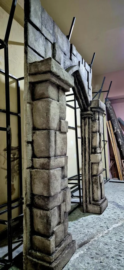Oblique workshop view of a Gothic-style doorway structure and its exposed supports.